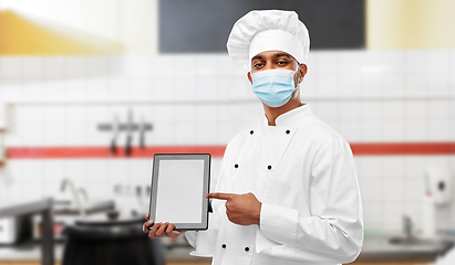 Image showing male chef in face mask with tablet pc at kitchen