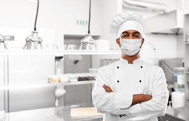 Image showing male chef in face mask at restaurant kitchen