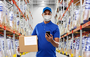 Image showing delivery man in mask with cellphone and parcel box