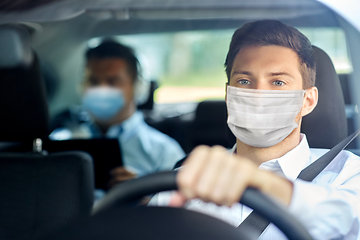 Image showing taxi driver in face protective mask driving car