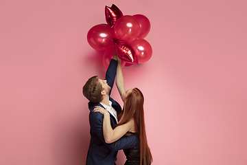 Image showing Valentine\'s day celebration, happy caucasian couple isolated on coral background