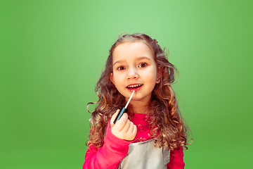 Image showing Little girl dreaming about future profession of makeup artist