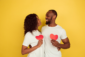 Image showing Valentine\'s day celebration, happy african-american couple isolated on yellow background