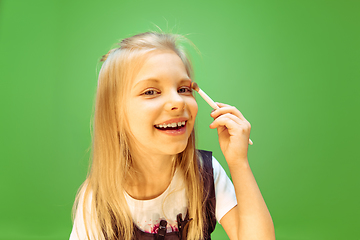 Image showing Little girl dreaming about future profession of makeup artist