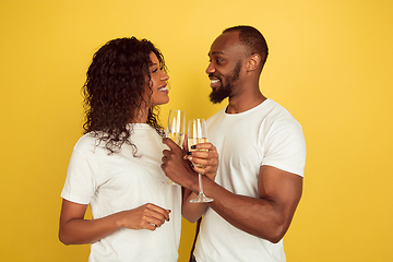 Image showing Valentine\'s day celebration, happy african-american couple isolated on yellow background