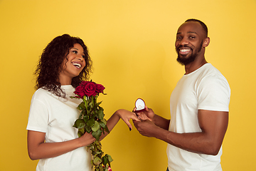 Image showing Valentine\'s day celebration, happy african-american couple isolated on yellow background