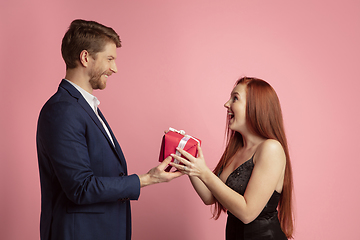 Image showing Valentine\'s day celebration, happy caucasian couple isolated on coral background