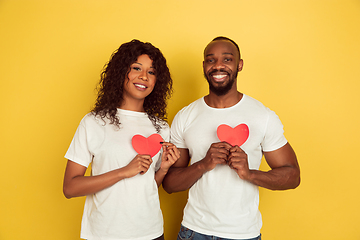 Image showing Valentine\'s day celebration, happy african-american couple isolated on yellow background