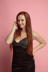 Image showing Portrait of young redhair caucasian woman isolated on coral background