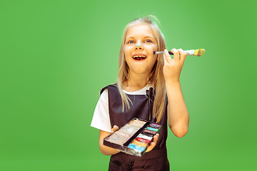 Image showing Little girl dreaming about future profession of makeup artist