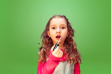 Image showing Little girl dreaming about future profession of makeup artist