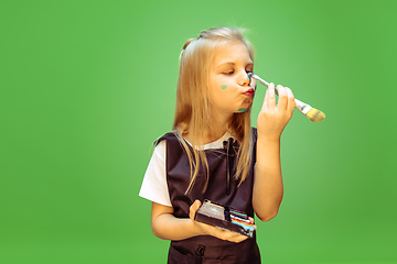 Image showing Little girl dreaming about future profession of makeup artist