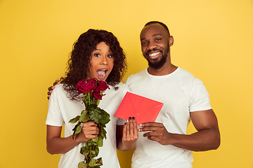 Image showing Valentine\'s day celebration, happy african-american couple isolated on yellow background