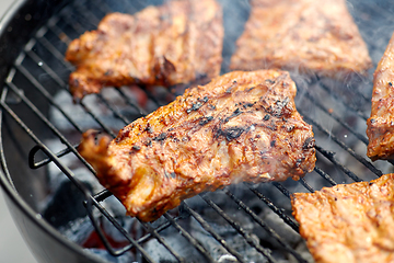 Image showing close up of barbecue meat roasting on grill