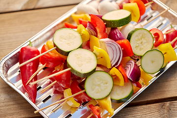 Image showing close up of vegetables on skewers on foil grill