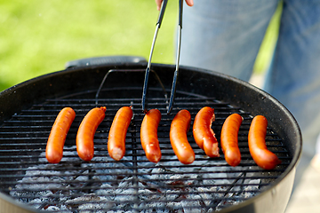 Image showing meat sausages roasting on hot brazier grill