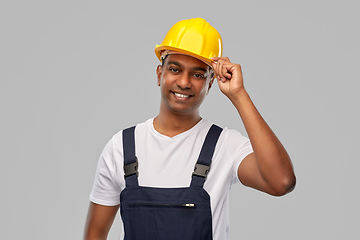 Image showing happy smiling indian worker or builder in helmet