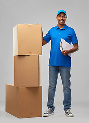 Image showing indian delivery man with boxes and clipboard