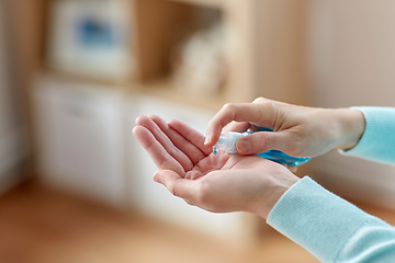 Image showing close up of woman spraying hand sanitizer