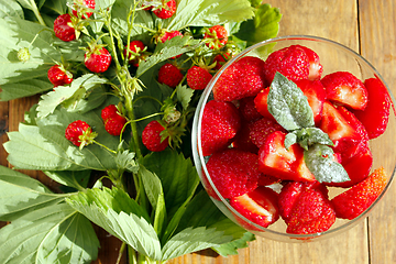 Image showing strawberries in a bowl and strawberries bunches