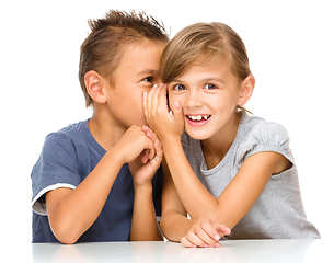 Image showing Little girl and boy are whispering in ear