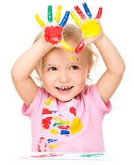 Image showing Portrait of a cute little girl playing with paints