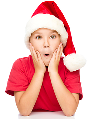 Image showing Little girl is holding her face in astonishment