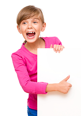 Image showing Little girl is looking out from the blank banner