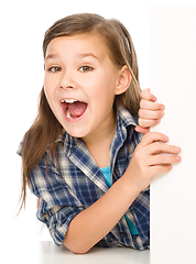 Image showing Little girl is looking from out blank board