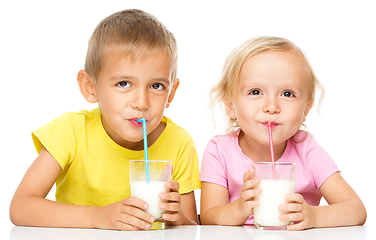 Image showing Cute little girl and boy are drinking milk