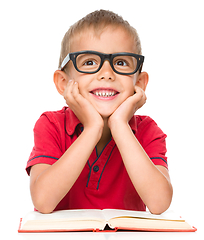 Image showing Little boy is reading a book