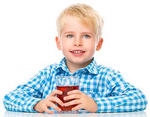 Image showing Little boy with glass of cherry juice