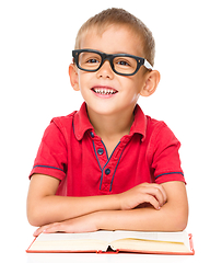 Image showing Little boy is reading a book