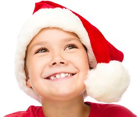 Image showing Little girl in santa hat is daydreaming