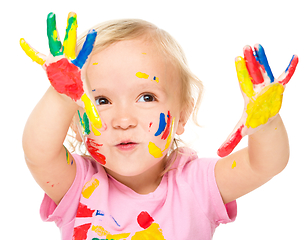 Image showing Portrait of a cute little girl playing with paints