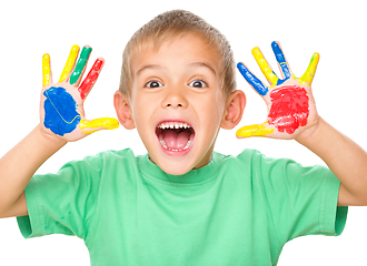 Image showing Portrait of a cute boy playing with paints