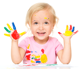 Image showing Portrait of a cute little girl playing with paints