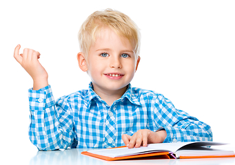 Image showing Little child play with book