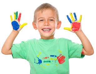 Image showing Portrait of a cute boy playing with paints