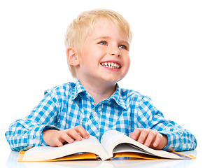 Image showing Little child play with book