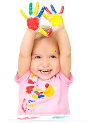 Image showing Portrait of a cute little girl playing with paints