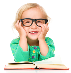 Image showing Little girl is reading her book