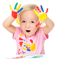 Image showing Portrait of a cute little girl playing with paints