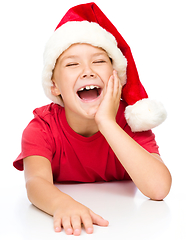 Image showing Little girl in santa hat is laughing
