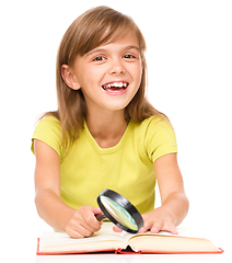 Image showing Little girl is reading book