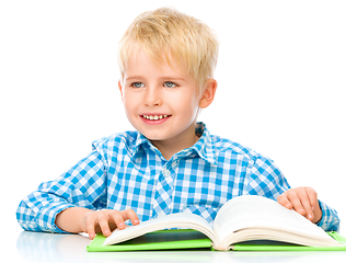 Image showing Little child play with book