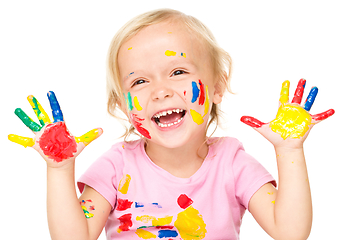 Image showing Portrait of a cute little girl playing with paints