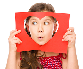 Image showing Little girl is looking through heart template