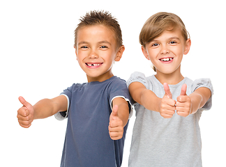 Image showing Little boy and girl are showing thumb up sign