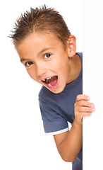 Image showing Little boy is looking out from the blank banner